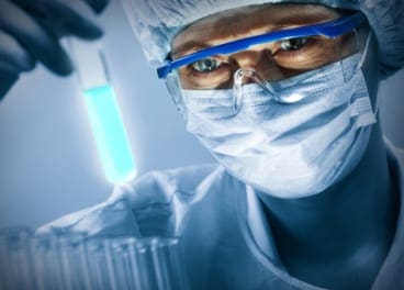 Medical researcher studying test tube