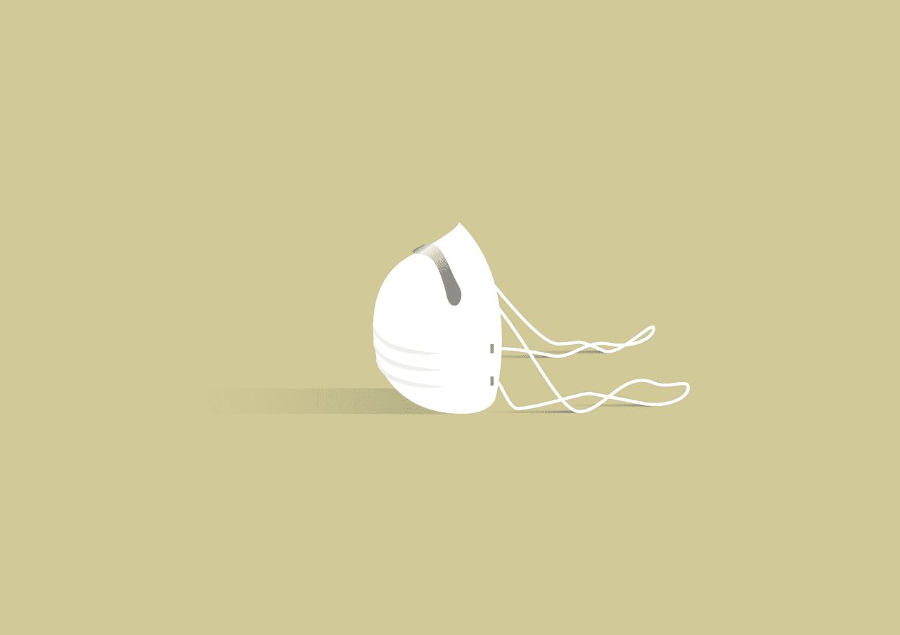 A white mask sitting on tan background