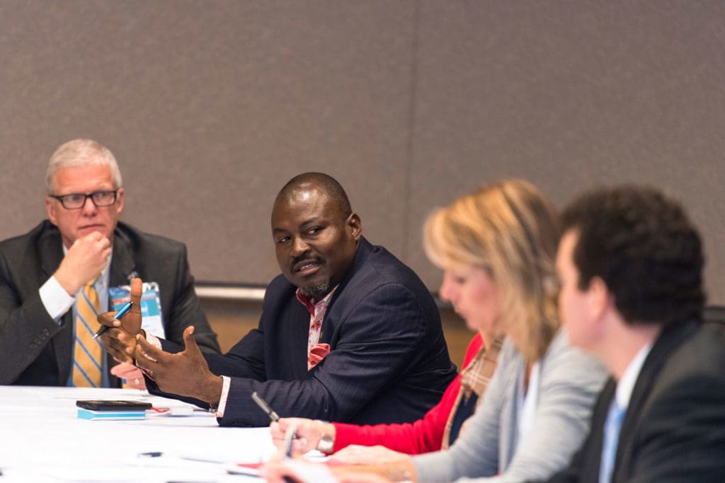 Multi-ethnic men and women at a committee meeting