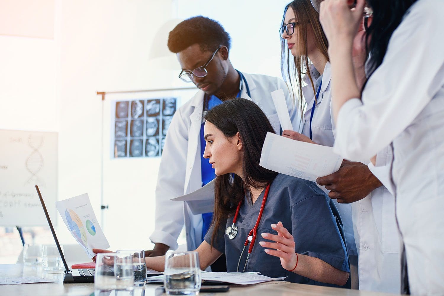 multi-ethnic group of medical students looking at computer screen together