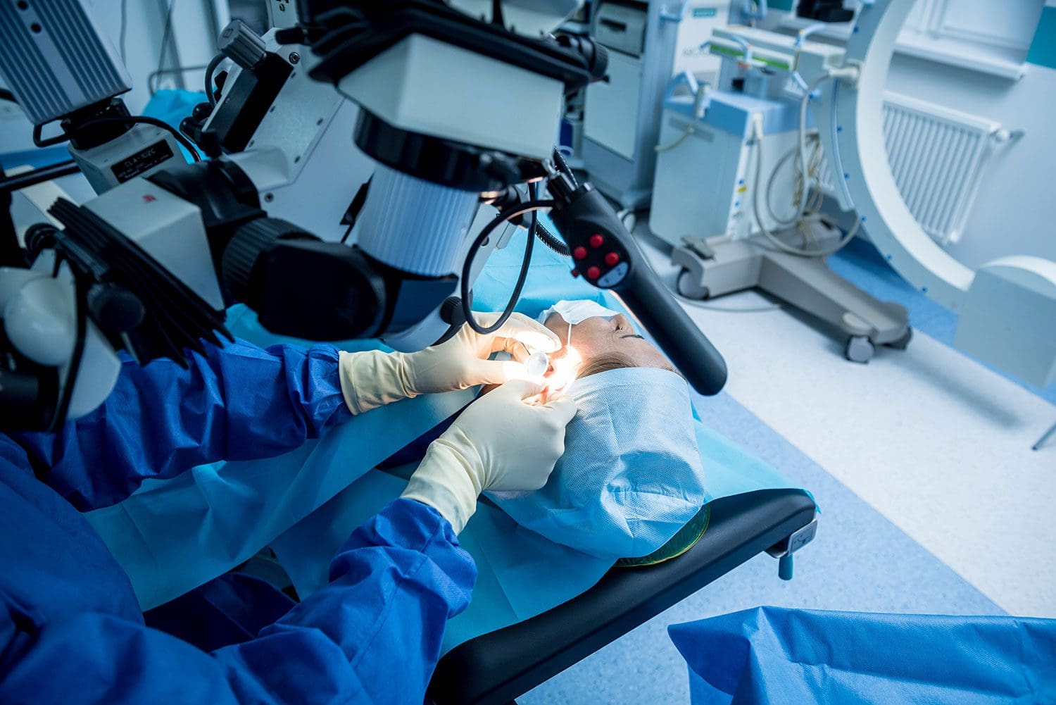 Otolaryngology performing ear procedure on female patient