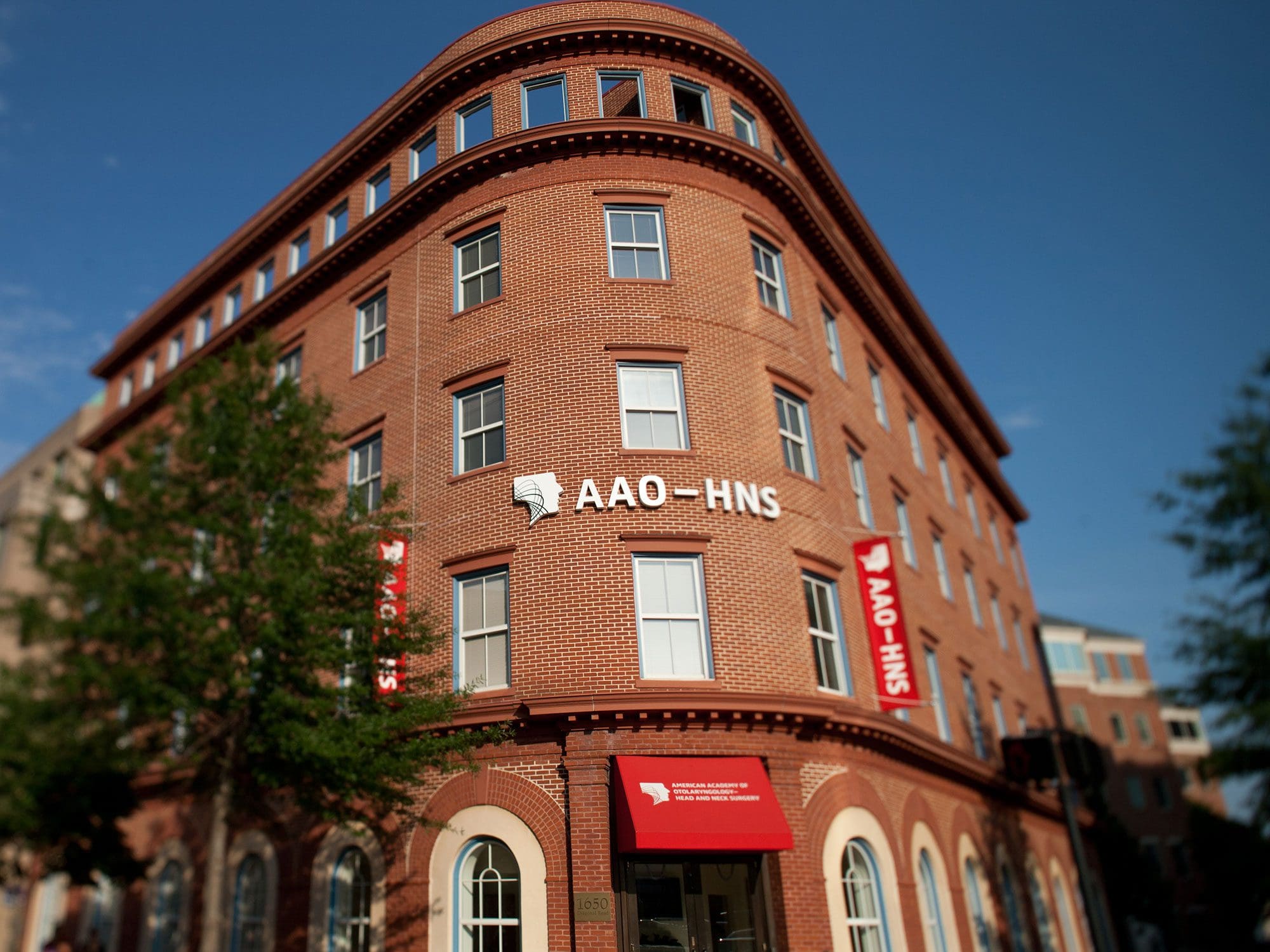 AAO-HNS Headquarter Building Photo with trees and blue sky