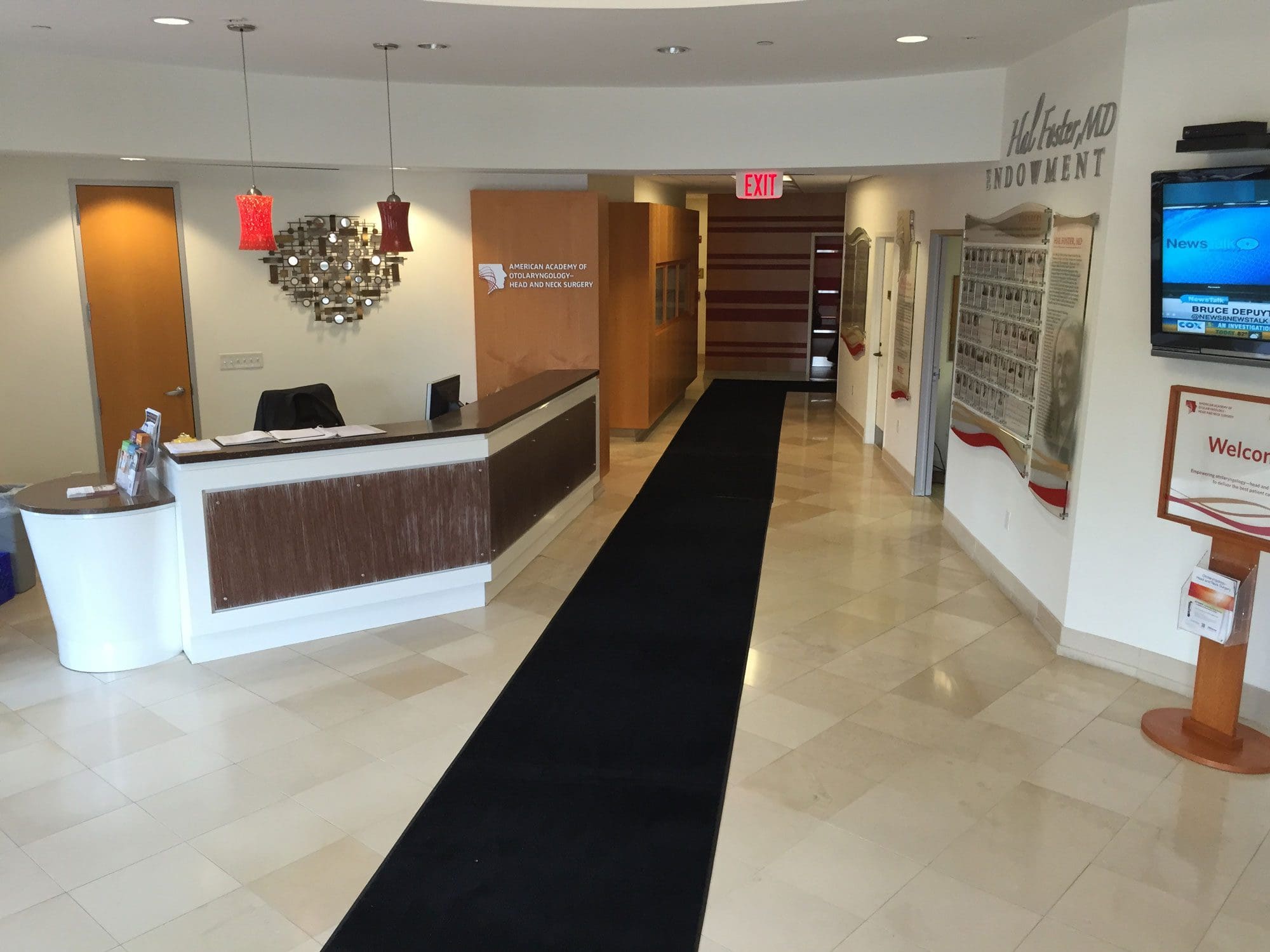 Building Lobby featuring security desk, elevator, and television